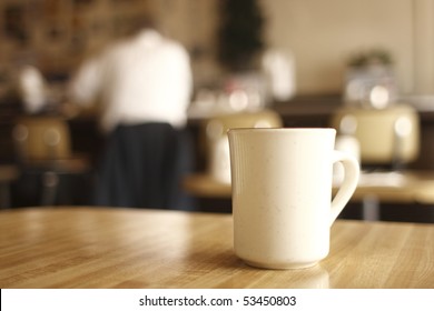 A Cup Of Coffee On The Table At A Diner.