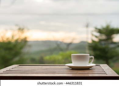 Cup Of Coffee On Table Outdoor Relaxing On Morning Light.