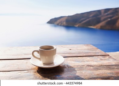 Cup Of Coffee On A Table Over Blue Sky And Sea. Summer Holiday Concept