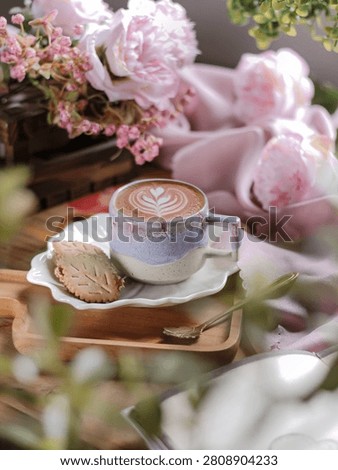 A cup of coffee on the table with pink peony flowers. Stilllife photography, selective focus
