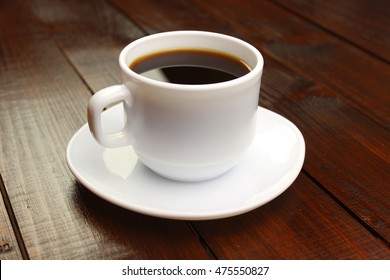 Cup of coffee on a wooden table - Shutterstock ID 475550827