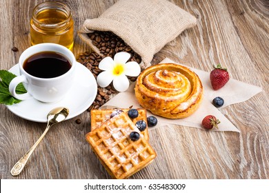 Cup Of Coffee And Pastry On Wooden Background