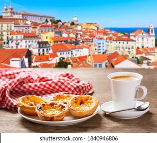 cup of coffee and plate of traditional portuguese pastries - Pastel de nata, over Alfama district, lisbon, Portugal