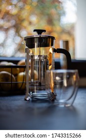 Cup Of Coffee And Pressure Coffee Maker On A Kitchen Table