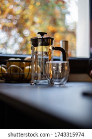 Cup Of Coffee And Pressure Coffee Maker On A Kitchen Table