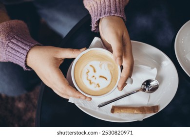 Cup with coffee and pumpkin face made from milk foam, minimal Halloween idea. A cup of coffee with Jack's scary face on it. Halloween latte art. Coffee latte art. Halloween coffee. Latte art. - Powered by Shutterstock