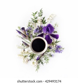 Cup Of Coffee With Purple Iris And Lily Of The Valley Flowers. Flat Lay, Top View