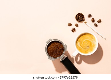 Cup of coffee, roasted coffee beans and filter holder at white background.