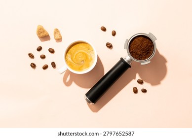 Cup of coffee, roasted coffee beans and filter holder at white background.