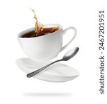 Cup of coffee, saucer and spoon in air on white background