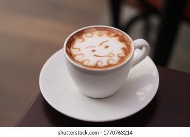 A Cup Of Coffee With A Smiley Latte Art