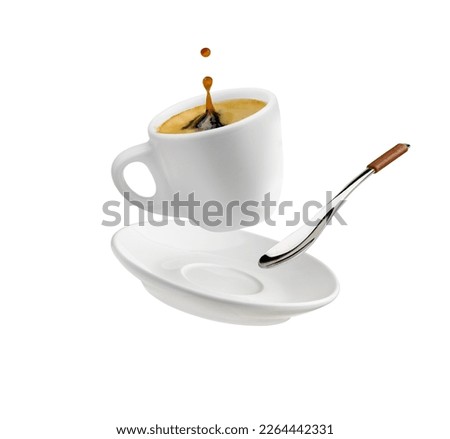 Cup of coffee with a splash drop fly with saucer and spoon isolated on white