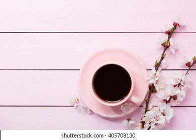 Cup of coffee and spring  flowers  on pink wooden table. - Powered by Shutterstock