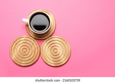 Cup of coffee and stylish wooden coasters on pink background, flat lay. Space for text - Shutterstock ID 2160103739