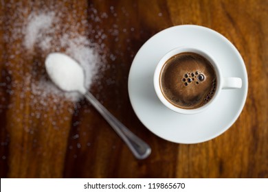 Cup Of Coffee With Sugar On Wooden Table