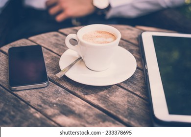 cup of coffee tablet and smart phone on wooden table - Powered by Shutterstock