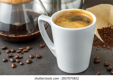 A Cup Of Coffee And Third Generation Pour Over Coffee Brewing Equipment On Stone Floor