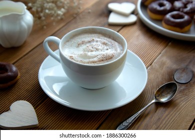 Cup Of Coffee,milk Saucer And Donuts, On Wooden Table With Copy Space, Top View.