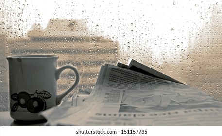 Cup Of Coffee,-newspaper And Rain Outside Window