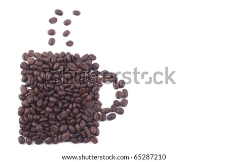 Cup of dark roasted coffee beans isolated on white