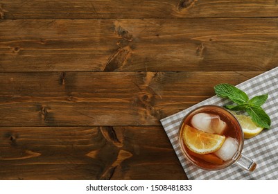 Cup Of Delicious Iced Tea On Wooden Table, Top View. Space For Text