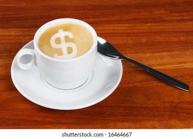 Cup of double shot cappuccino with dollar sign made with frothing milk in the coffee foam, The froth of the dollar sign is not very detailed with bubbles etc due to manipulation in creating the sign