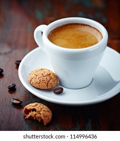 Cup of espresso and biscotti. Cup of coffee with a sweet cookie and coffee beans. Symbolic image. Rustick wooden background. Close up. 
 - Shutterstock ID 114996436