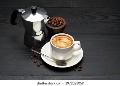 Cup Of Espresso Coffee And Mocha Coffee Maker On Dark Wooden Background