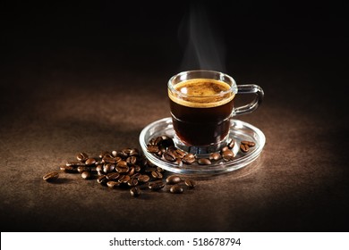 Cup of espresso coffee on dark background.