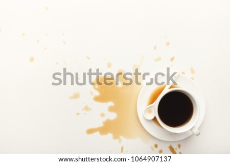 Cup of espresso and coffee spilt on white isolated background, top view. Mockup for grunge advertisement design, copy space