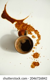 Cup Of Espresso On Spilled Coffee Spots On White Background, Top View