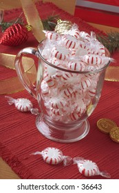 Cup filled with peppermint candy.