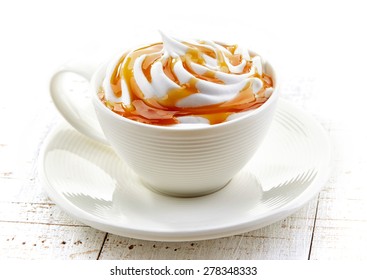 cup of a fresh caramel latte with whipped cream