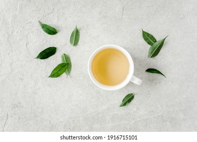 Cup Of Fresh Green Tea With Tea Leaves. Flat Lay, Top View. Tea Concept