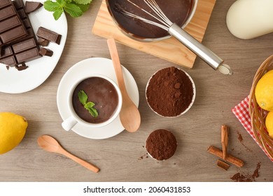 Cup Of Fresh Homemade Hot Chocolate With Ingredients On The Kitchen Bench. Top View.