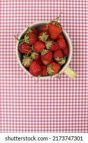 Cup Of Fresh Strawberries On A Red Gingham Background