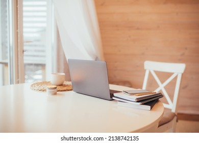 Cup With Fresh Tea, Laptop, Notebooks And Smartphone On A White Table. Work From Home.