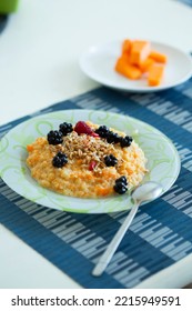 Cup Of Freshly Brewed Pumpkin Porridge With Berries On The Table. Healthy Food Idea