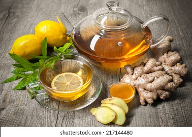 Cup of ginger tea with honey and lemon on wooden table - Powered by Shutterstock