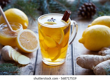 Cup of green natural tea with ginger, lemon and honey on wooden vintage background. Healthy drink. Hot winter beverage concept.