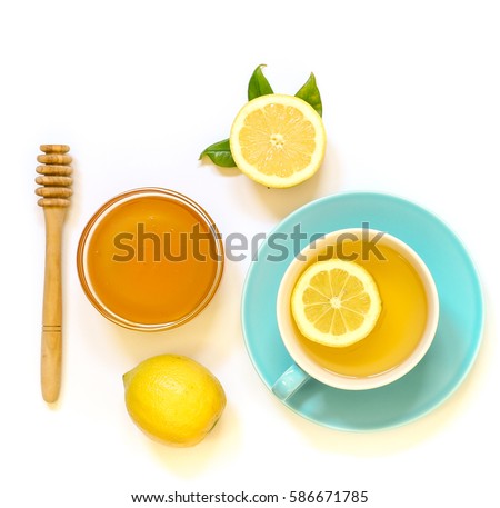 Cup of green tea with lemon and honey isolated on white background. View from above.