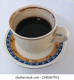 A Cup Half Full Of Black Coffee Without Sugar