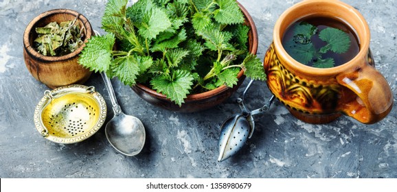 Cup of healthy herbal tea with nettle.Tea with nettles.Fresh stinging nettles