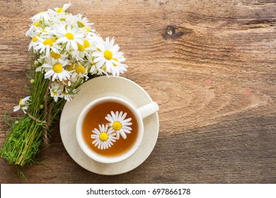 cup of herbal chamomile tea with camomile dry blossoms, dried camomile flowers. doctor treatment and prevention of immune concept, medicine - folk, alternative, complementary, traditional medicine