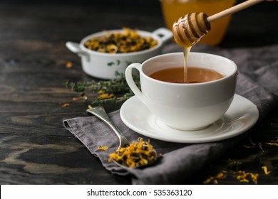 Cup with herbal tea and honey and dry herbal tea - Powered by Shutterstock