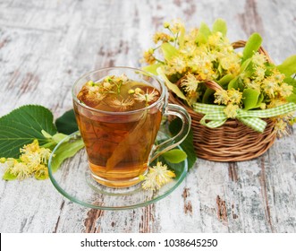 cup of herbal tea with linden flowers on a old wooden background - Shutterstock ID 1038645250