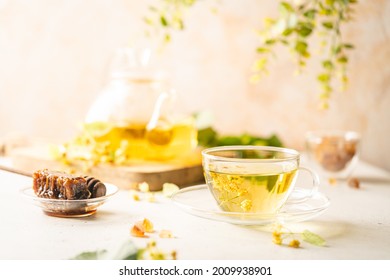 Cup Of Herbal Tea With Linden Flowers On White Background