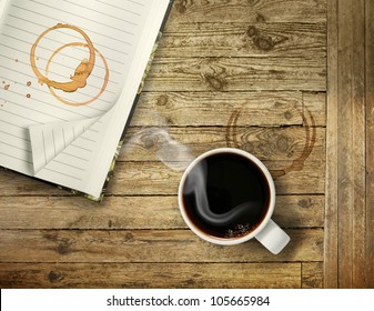 Cup Of Hot Black Coffee On Rough Wooden Table With Stain Rings