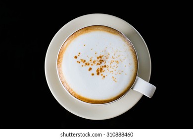 Cup Of Hot Cappuccino With Black Background, View From Above