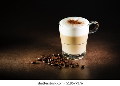 Cup Of Hot Cappuccino Coffee On Dark Background.